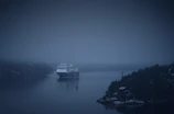 Captain Lance navigating through misty fjords during an expedition.