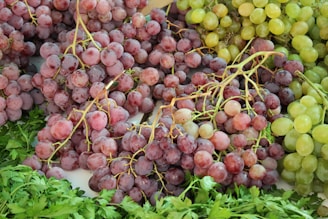 a bunch of grapes sitting on top of a table