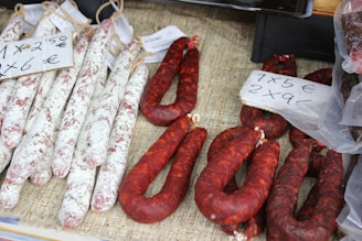 several sausages are on display for sale at a market