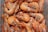 A close-up view of a pile of boiled shrimp with their shells still on, visible black eyes, and whiskers. The shrimp are laid out in a way that shows their pinkish-orange hue and shiny, slightly wet texture.