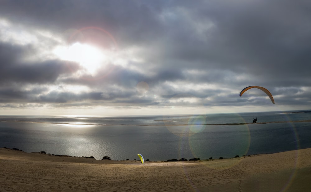 a person para sailing on a body of water under a cloudy sky