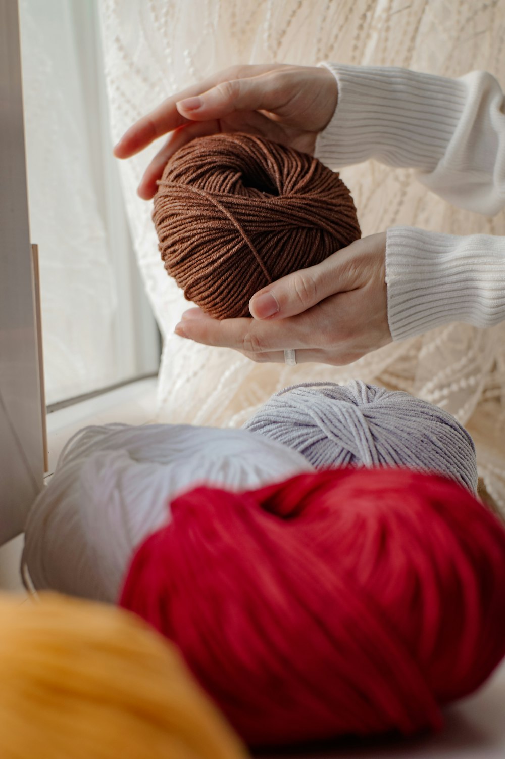 a person holding a ball of yarn in their hands
