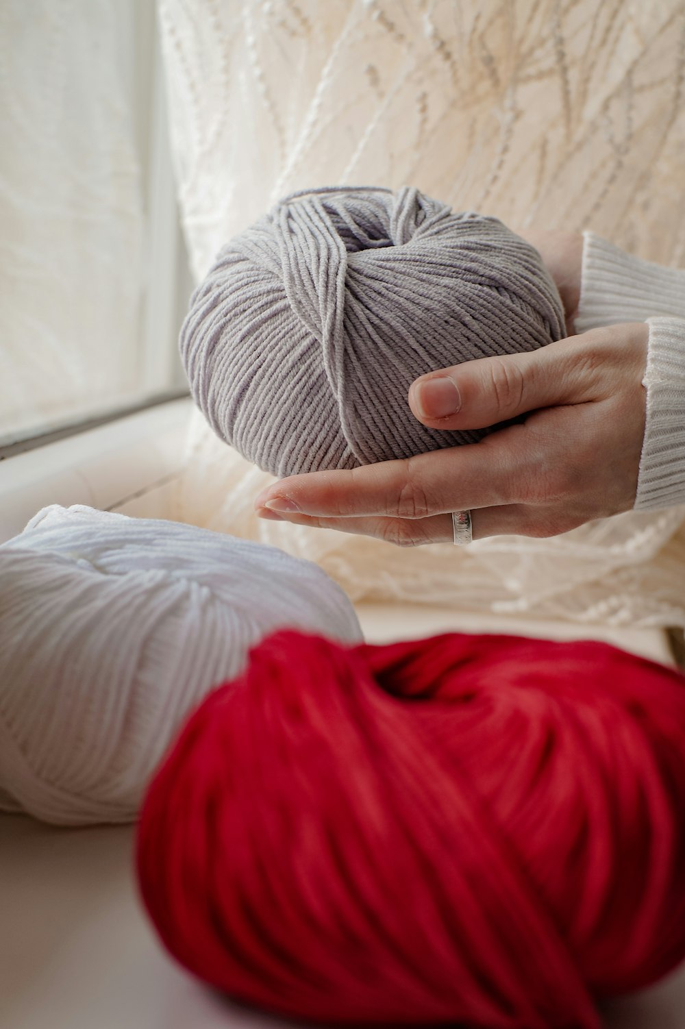 a person holding a ball of yarn in their hand