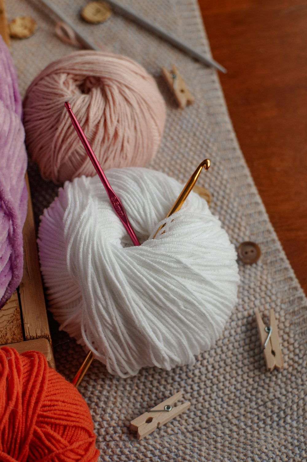 three balls of yarn sitting on top of a table