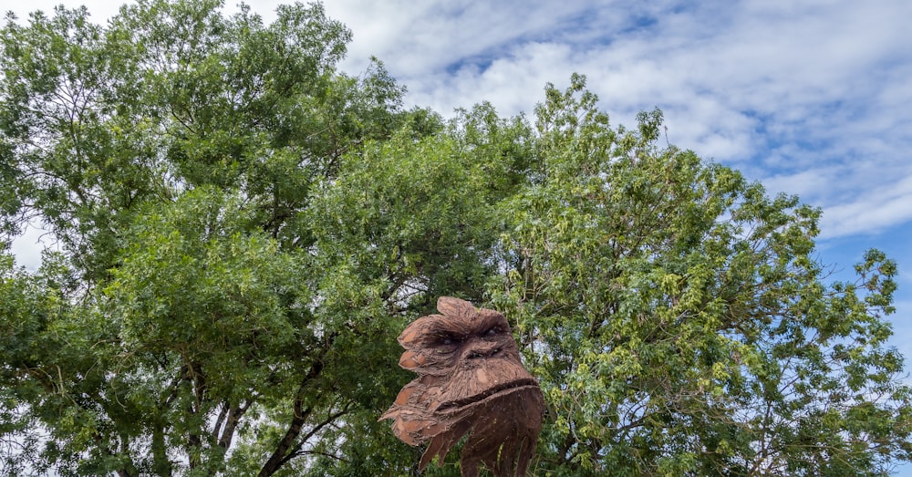 a statue of a bird in the middle of a tree