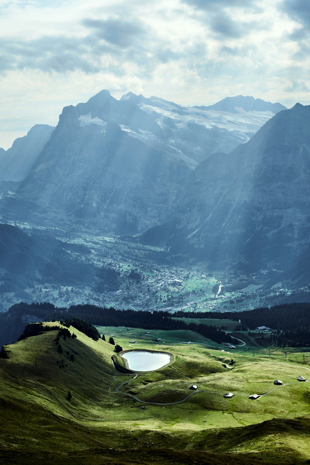 a view of a mountain range with a lake in the foreground