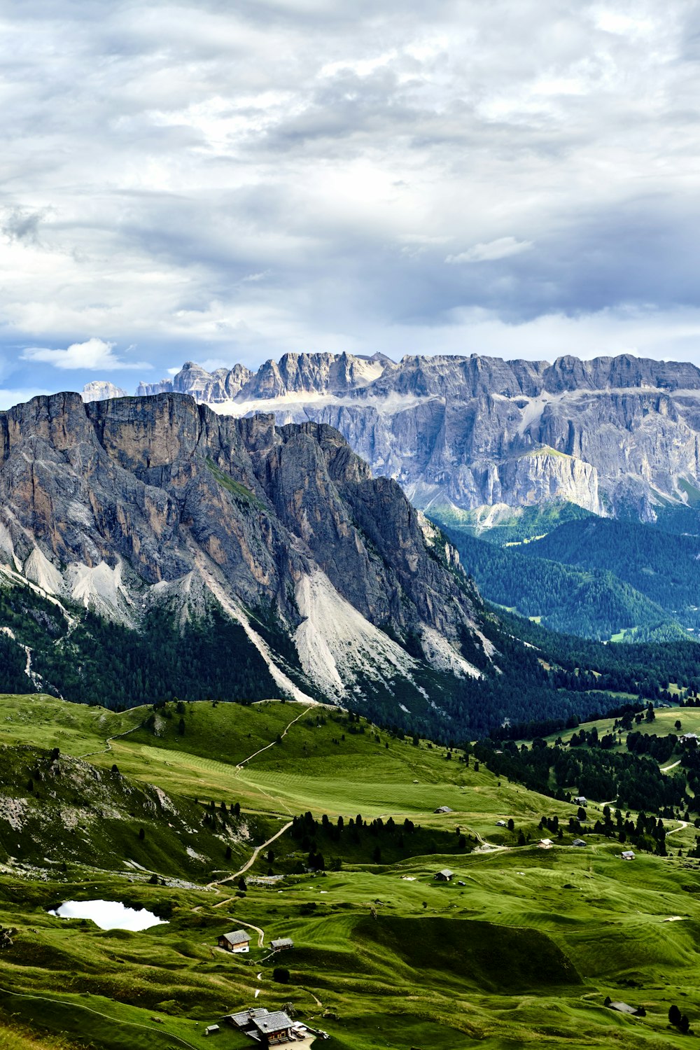 a scenic view of a valley with mountains in the background