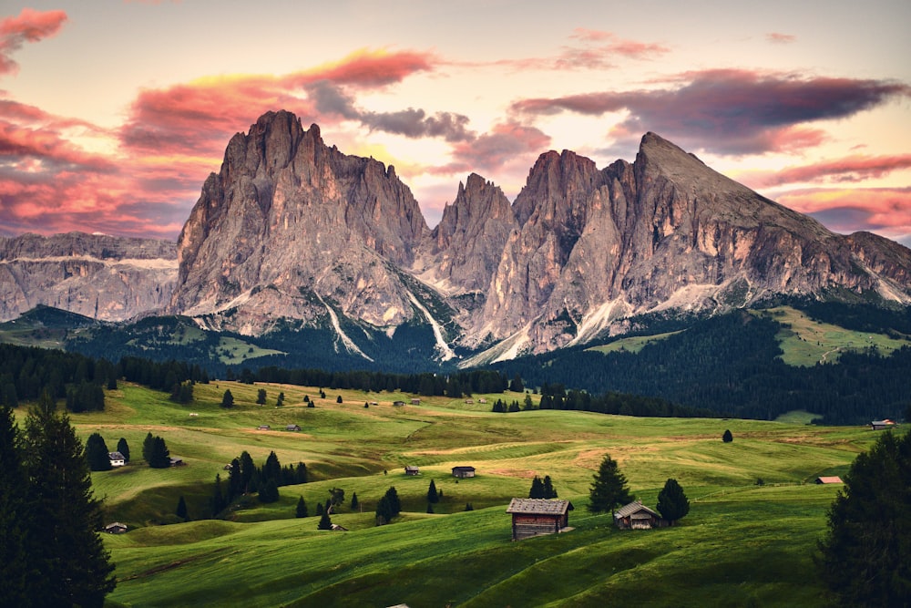 a scenic view of a mountain range at sunset