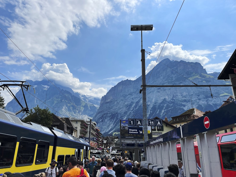 a crowd of people standing next to a train