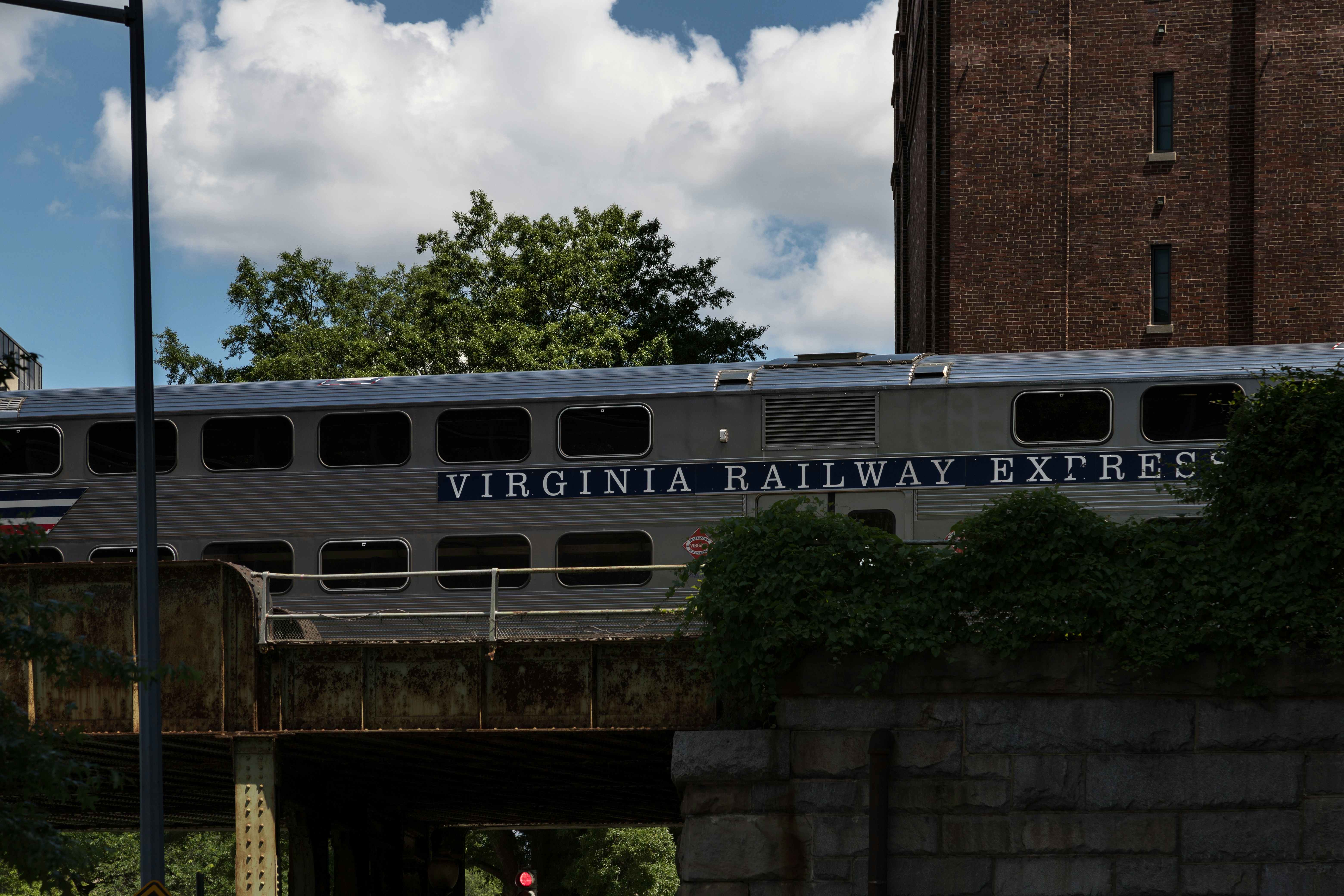 a train traveling over a bridge next to a tall building