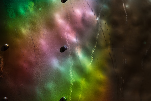 Close-up of vibrant, glossy slime textures in various colors and sparkles.