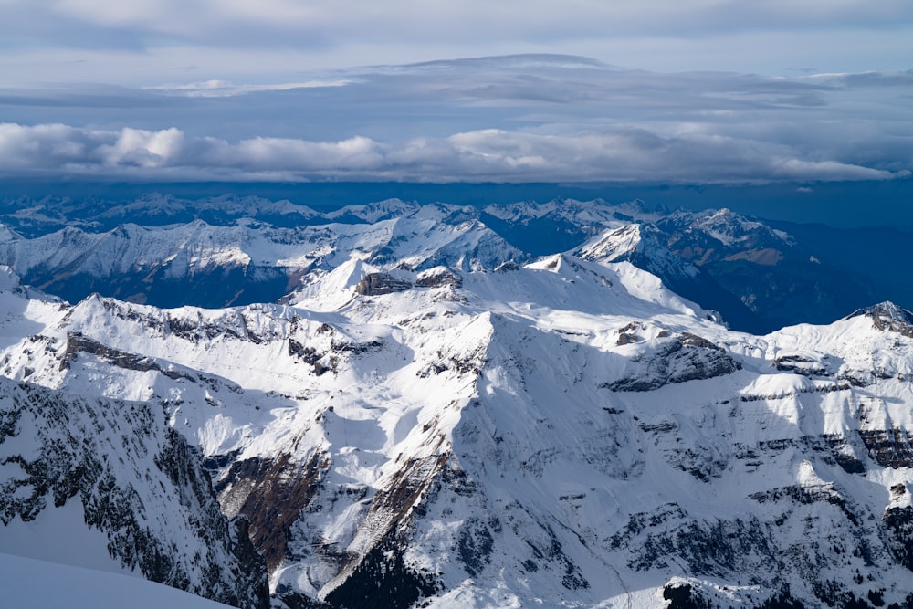 a view of a snowy mountain range from a plane
