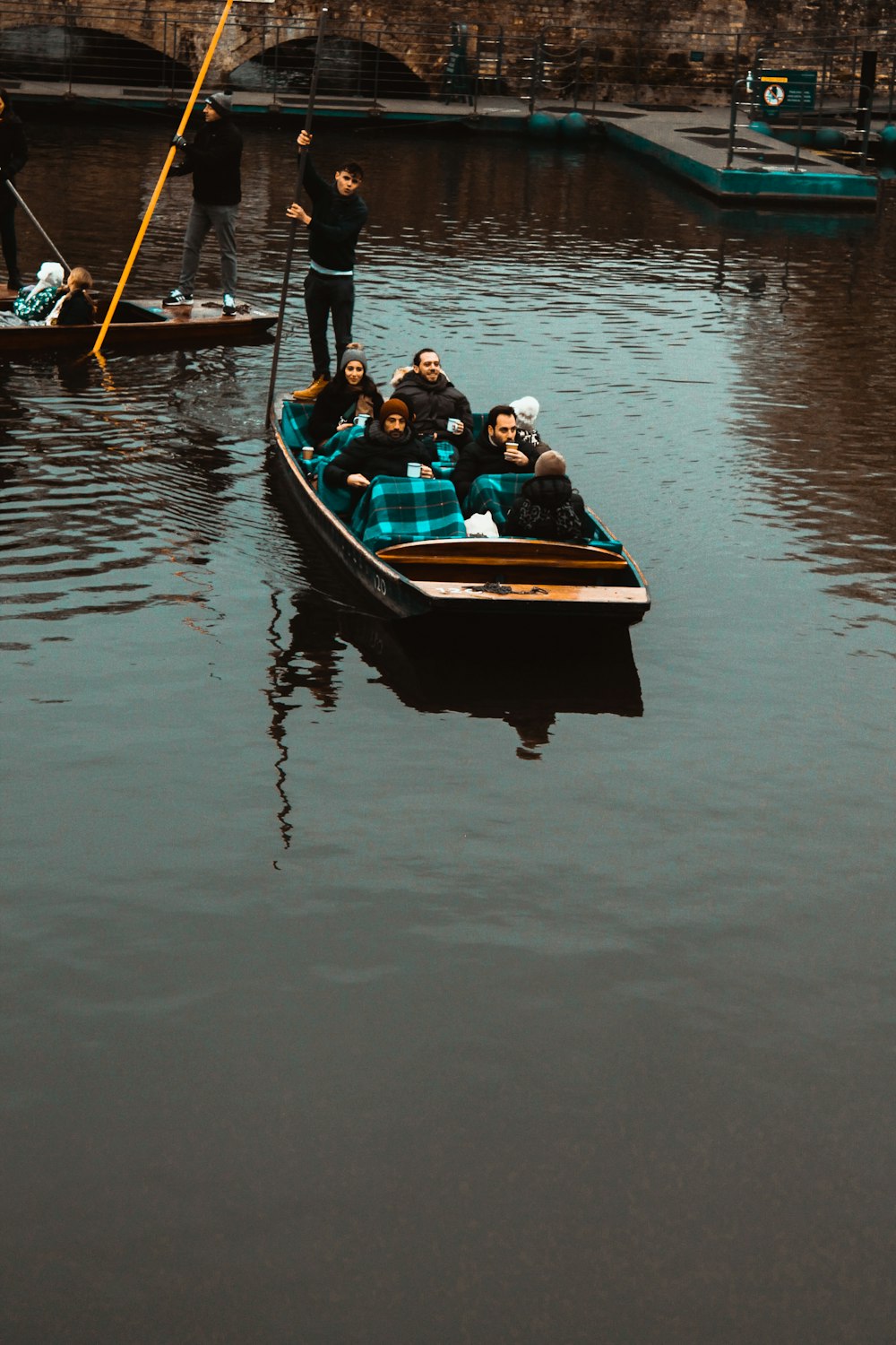 a group of people in a boat on a body of water