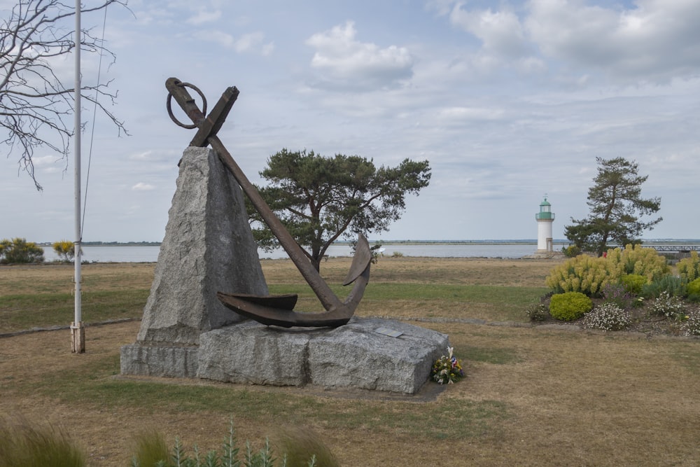 a statue of a boat and anchor on a rock