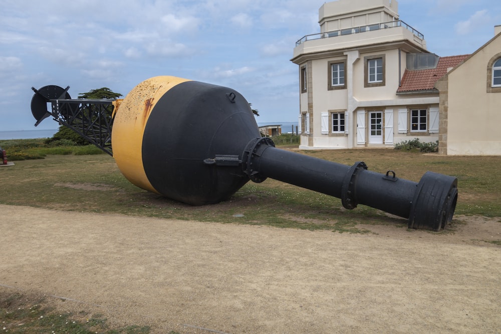 a large cannon sitting on top of a grass covered field