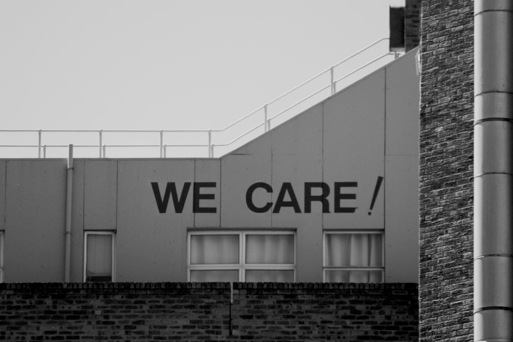 a black and white photo of a building with a sign that says we care