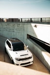 a white jeep cherokee om premium car tyres in a parking garage