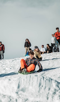 A joyful person snowboarding down a snowy mountain slope.