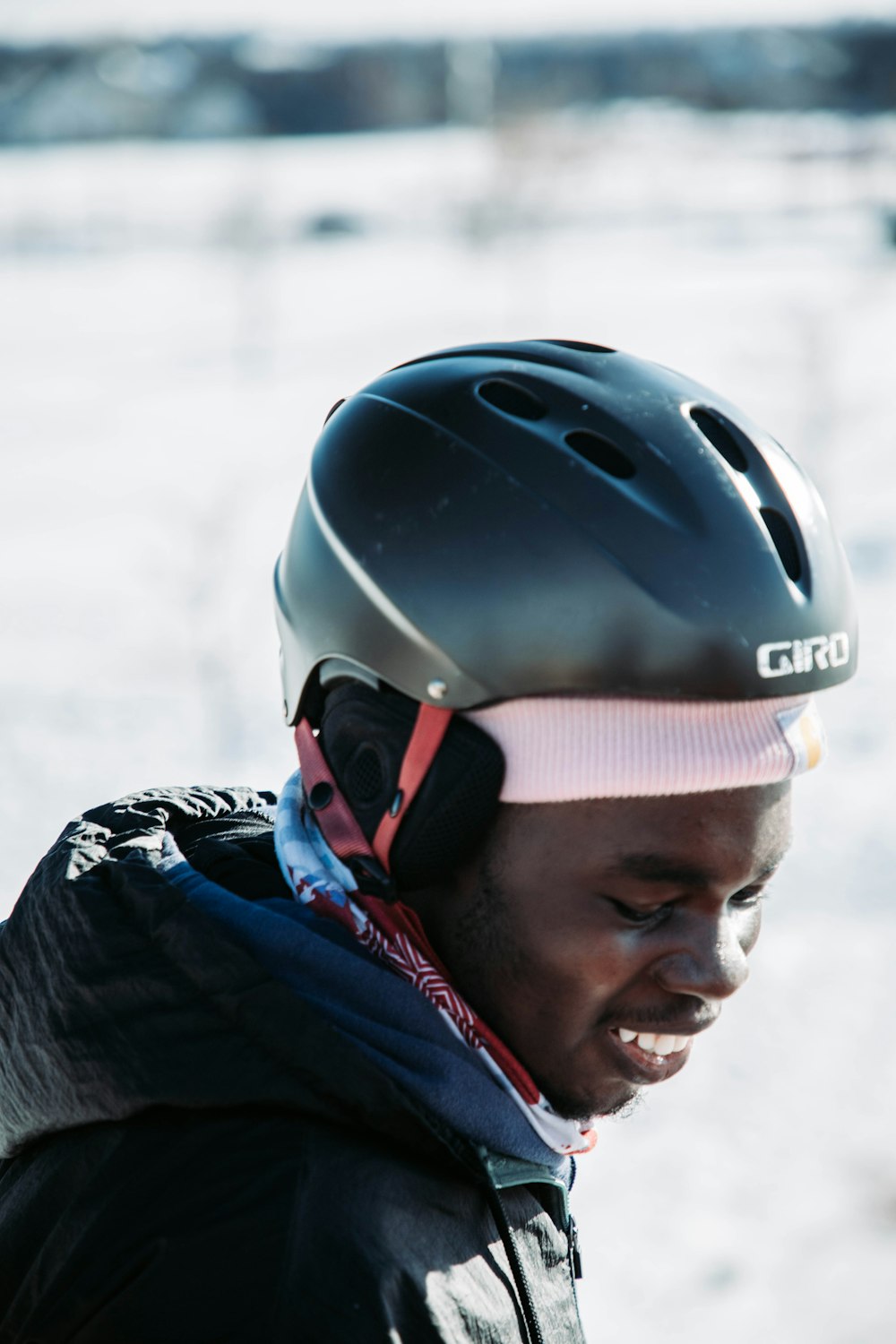 a man wearing a helmet while standing in the snow