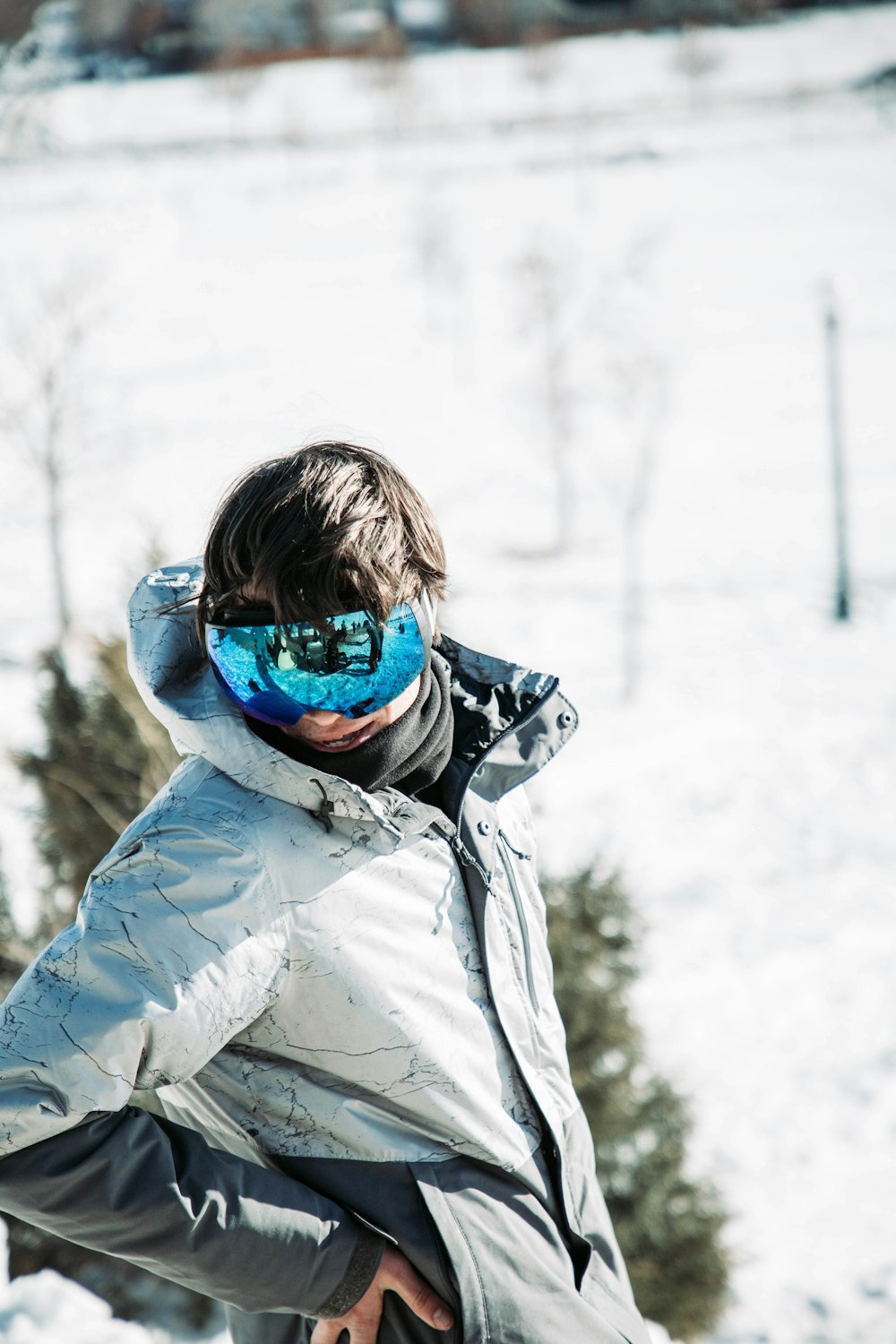 a man riding a snowboard down a snow covered slope