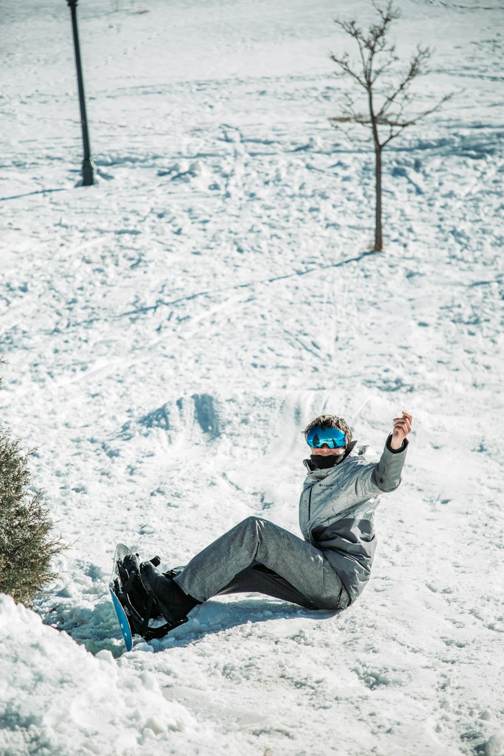 a person laying in the snow with a snowboard