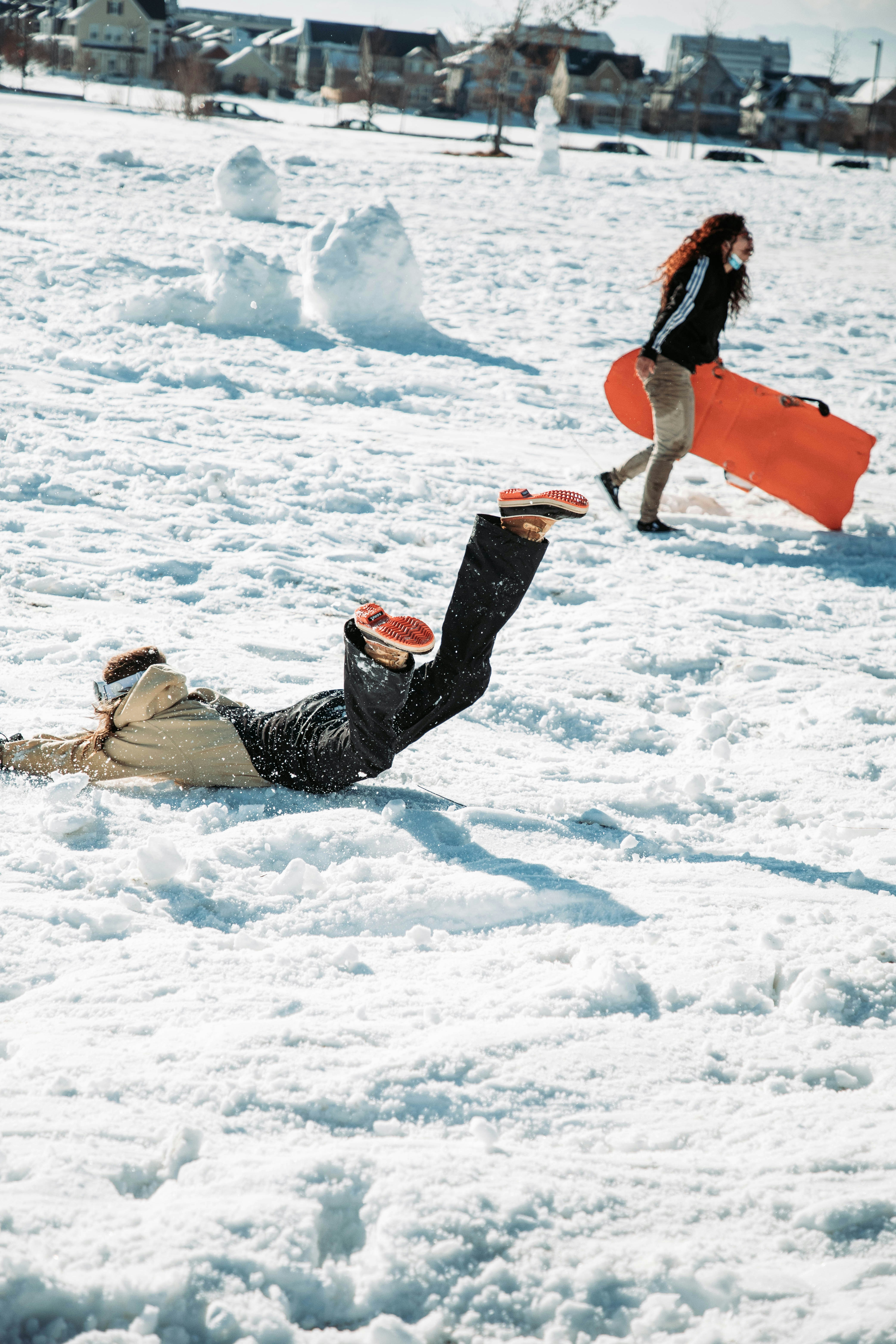 A person laying in the snow with a snowboard photo – Free Denver Image ...