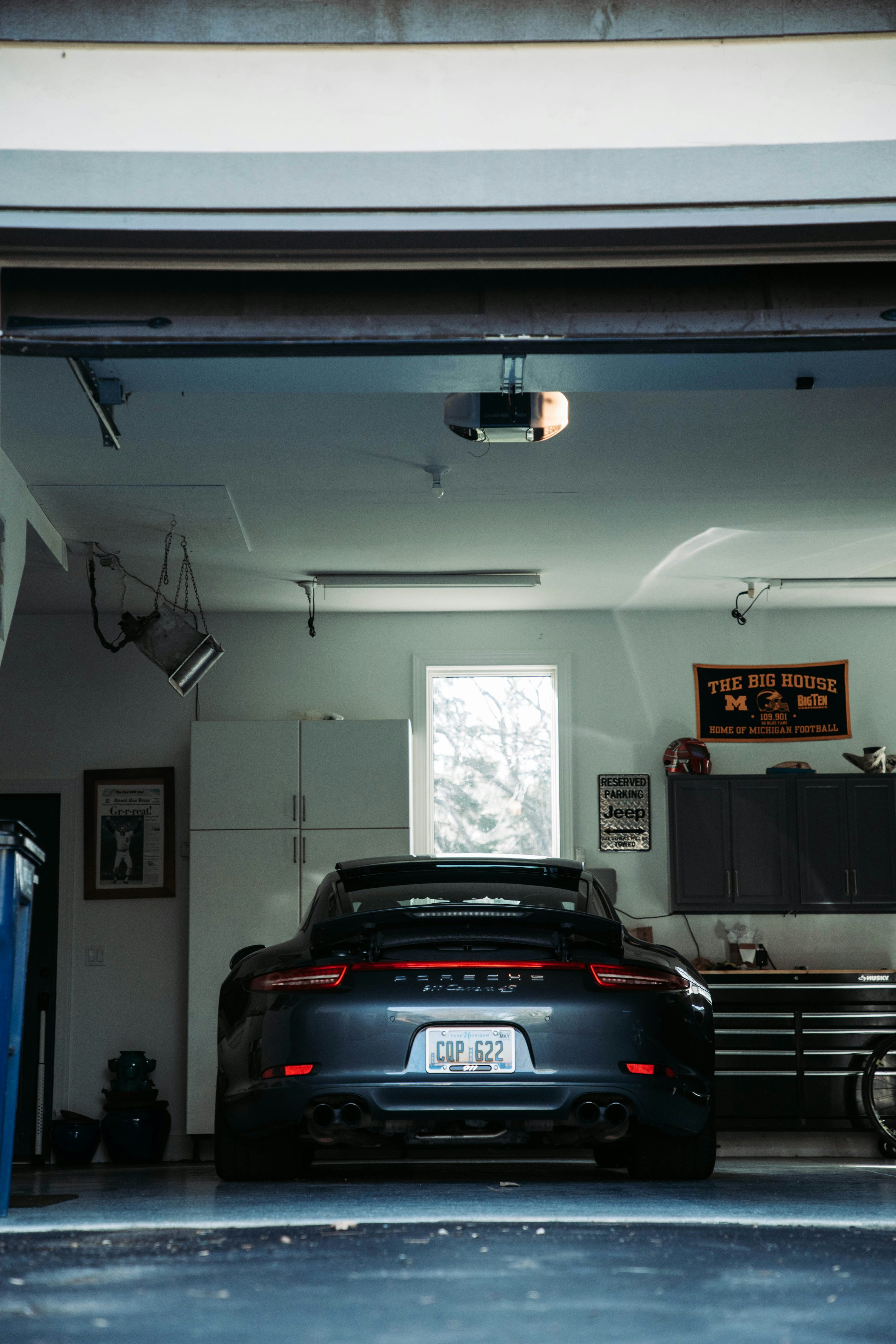 a car parked inside of a garage next to another car