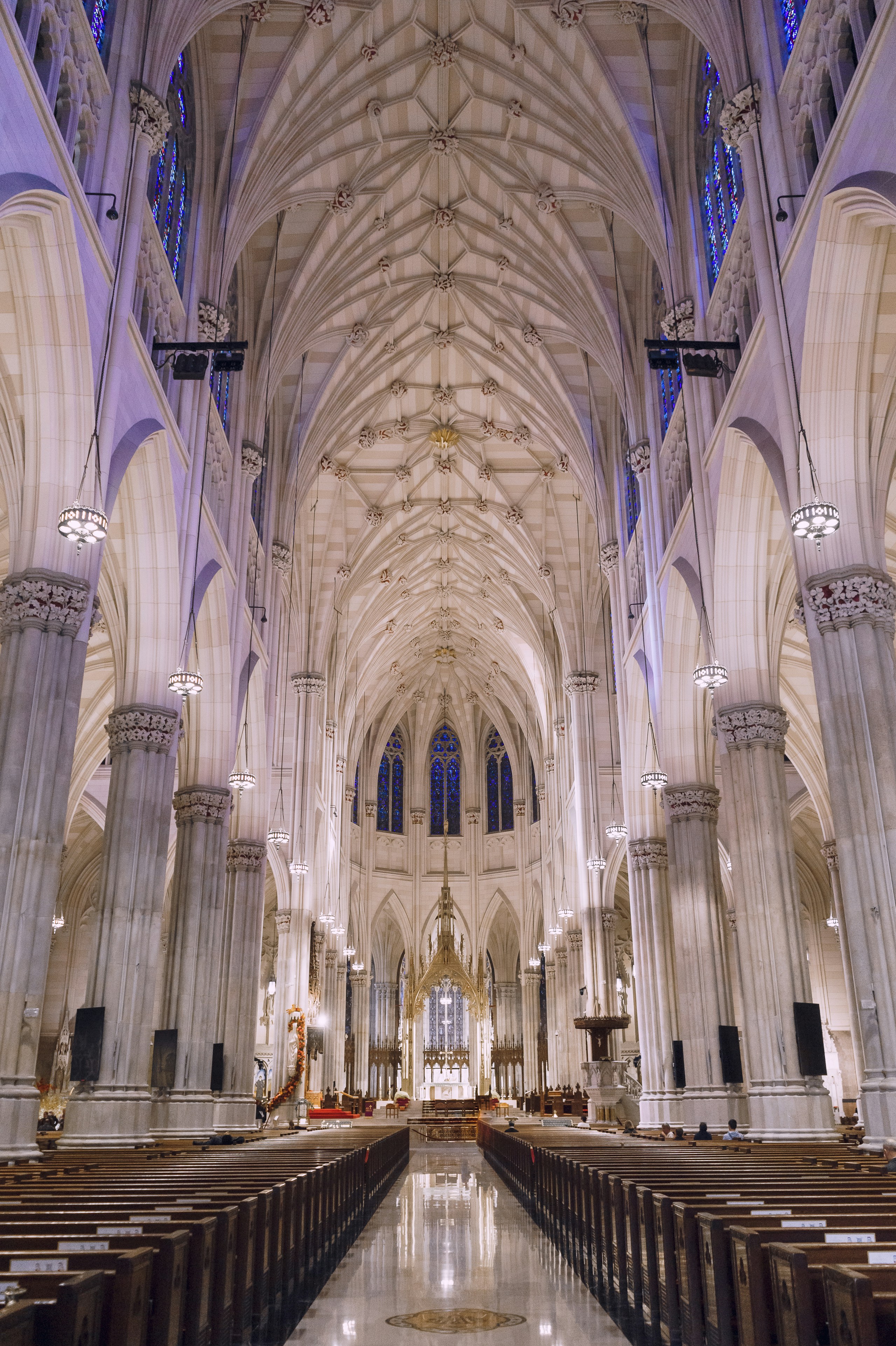 the inside of a large cathedral with pews