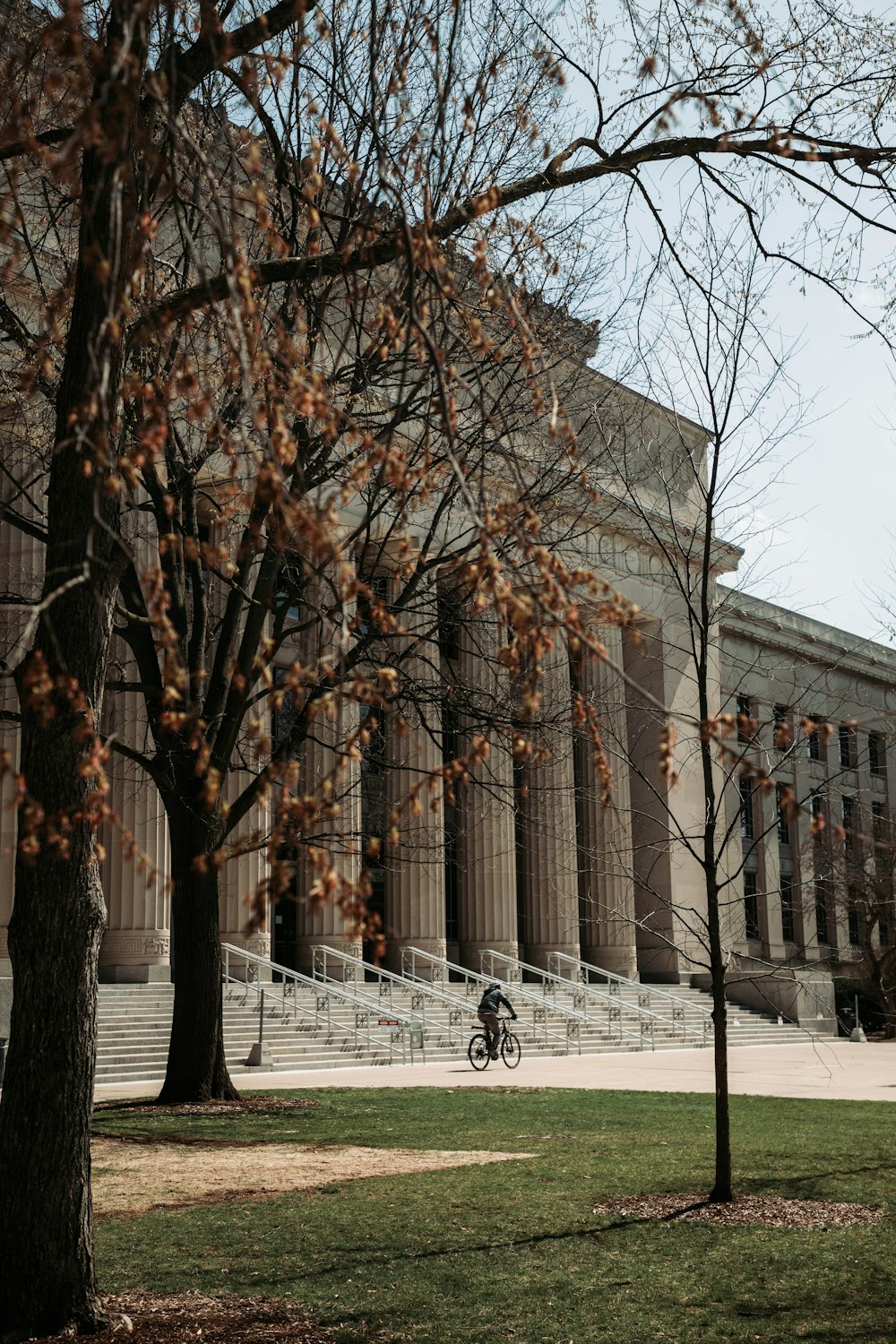 a person riding a bike in front of a building