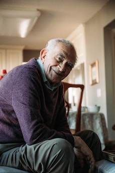 A compassionate nurse assisting an elderly patient in a bright, home-like setting