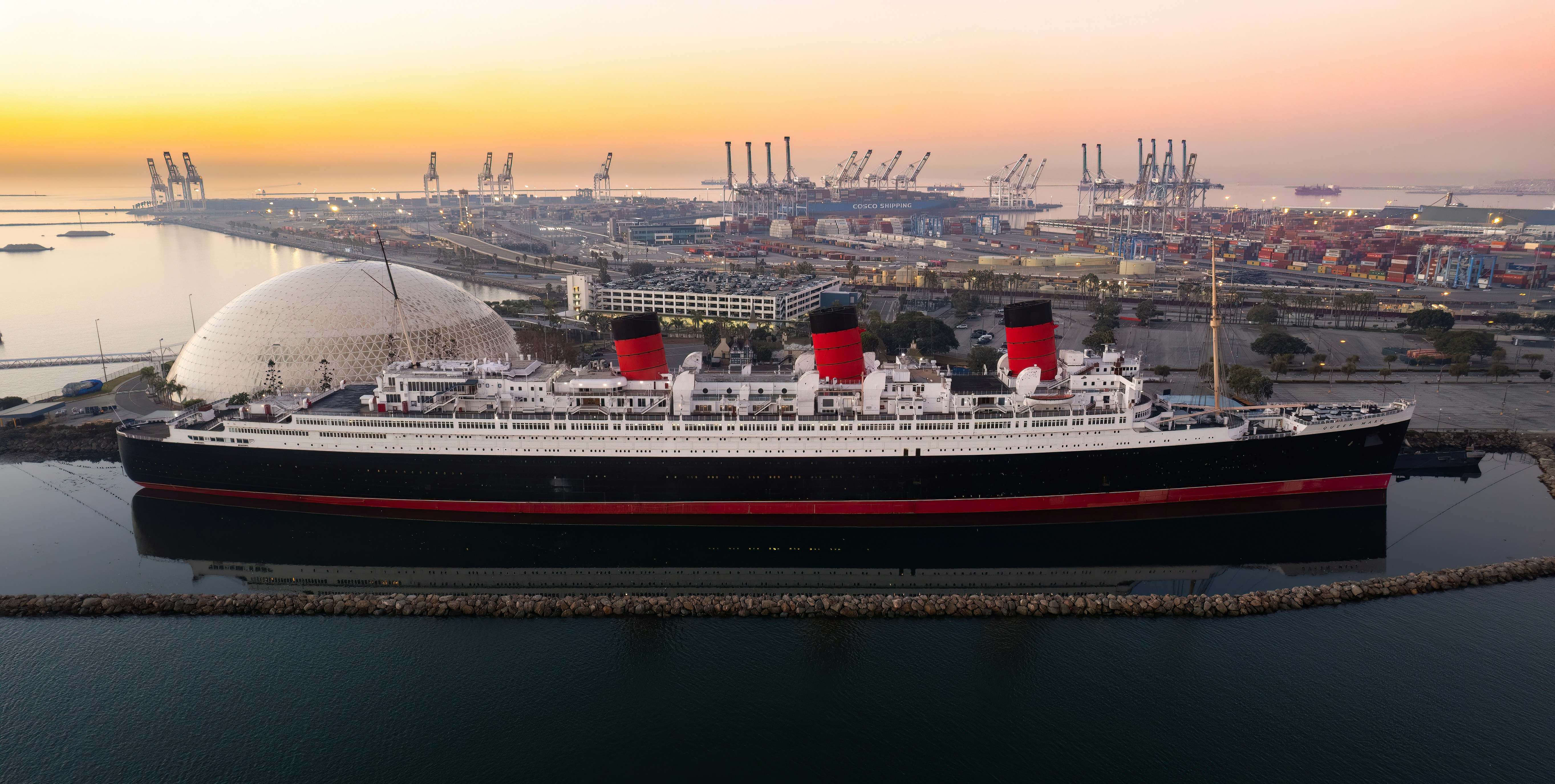 a large cruise ship docked in a harbor, Queen Mary @ Sunrise, Long Beach, CA