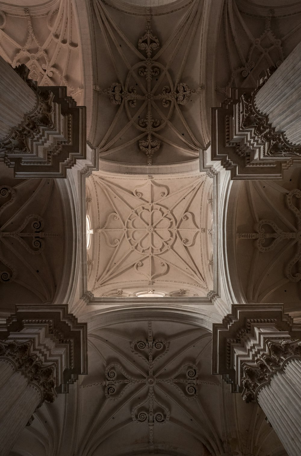 the ceiling of a building with intricate designs