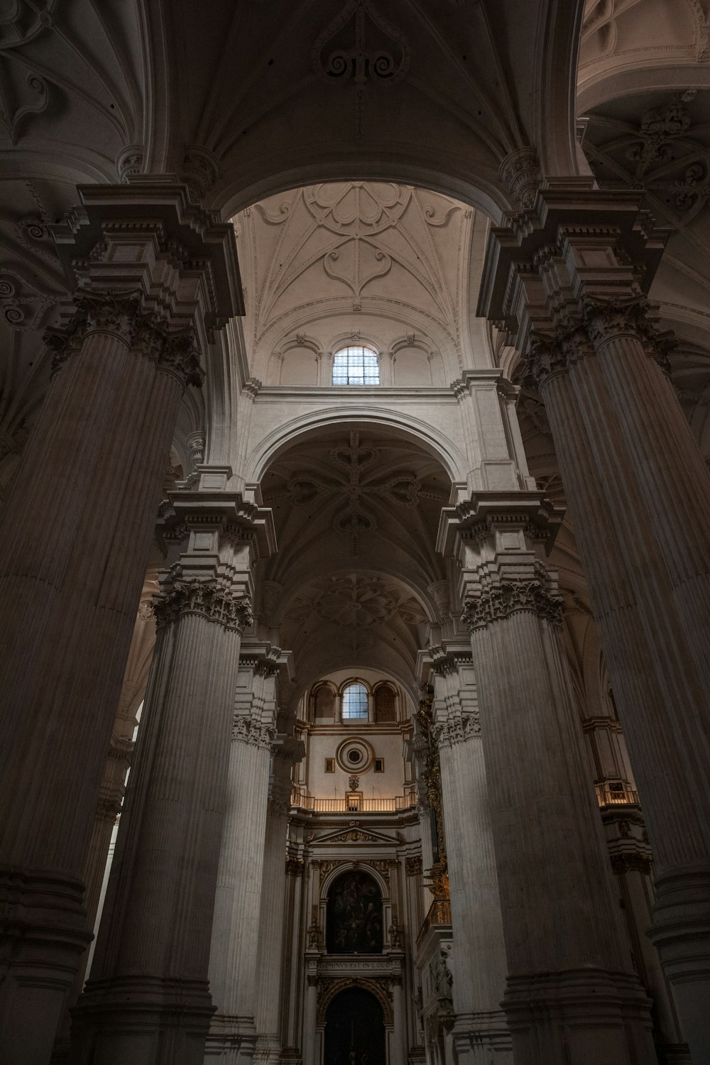 a church with columns and a clock on the wall