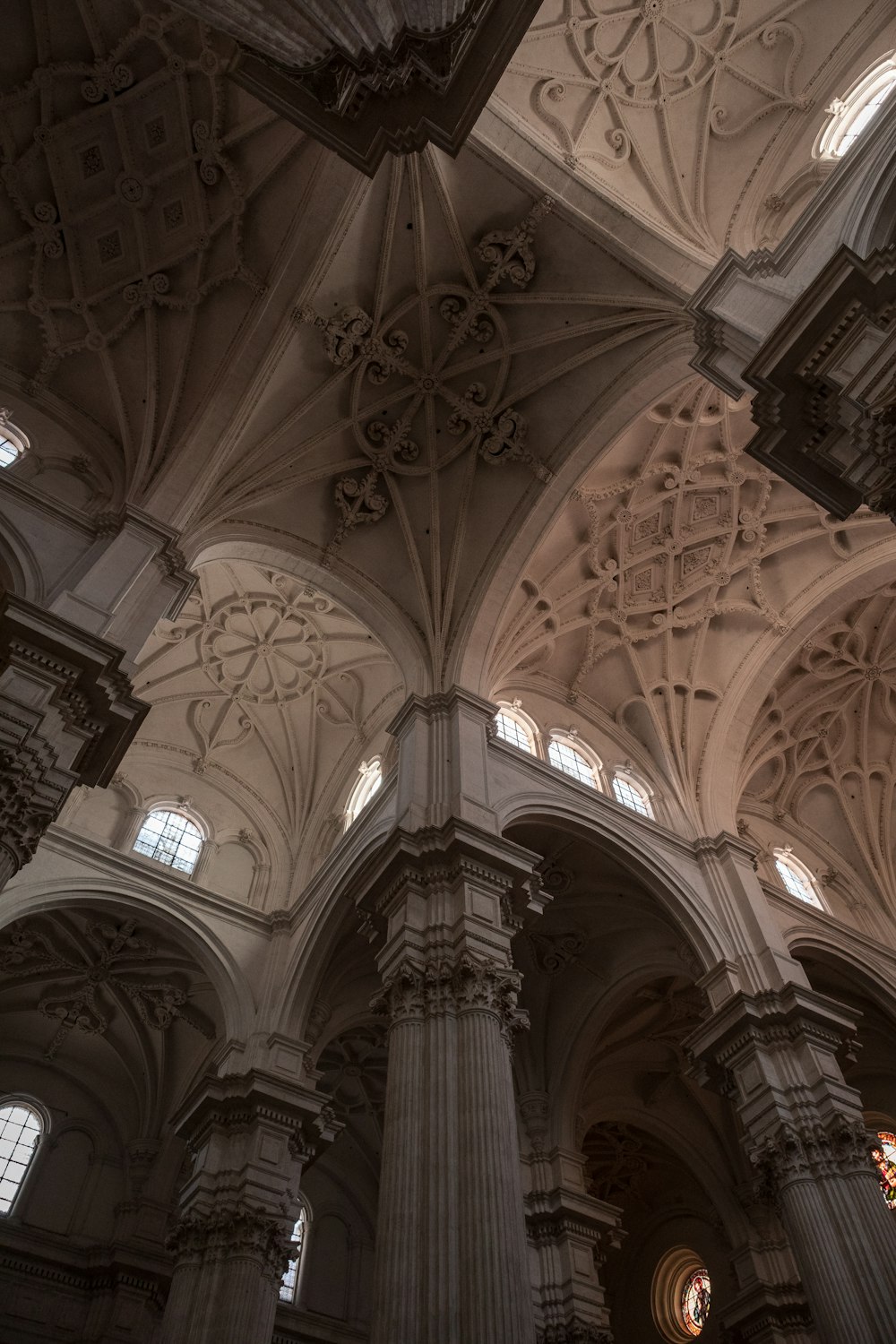 the ceiling of a large cathedral with many windows
