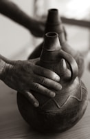 A close-up of hands holding traditional African crafts.