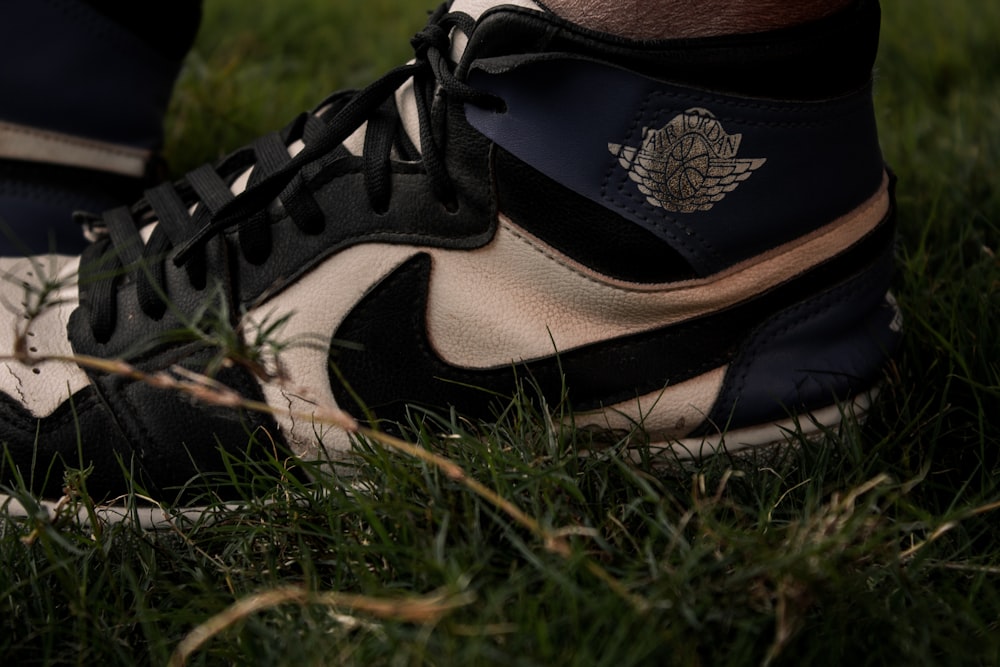a close up of a person's shoes in the grass