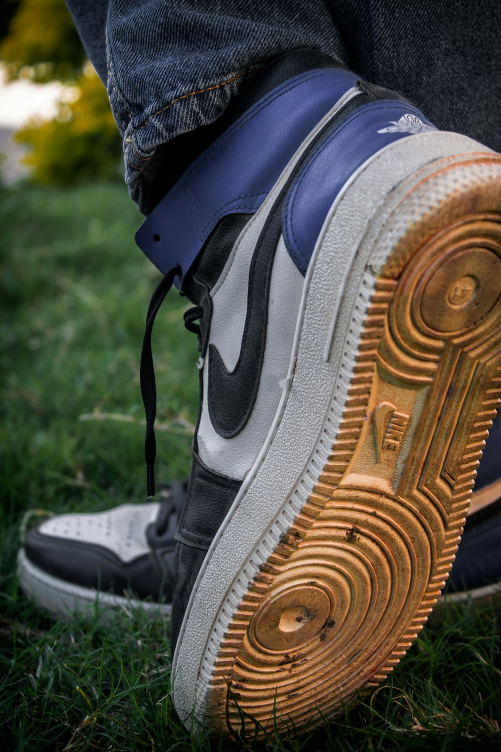 a close up of a person's shoe on the grass