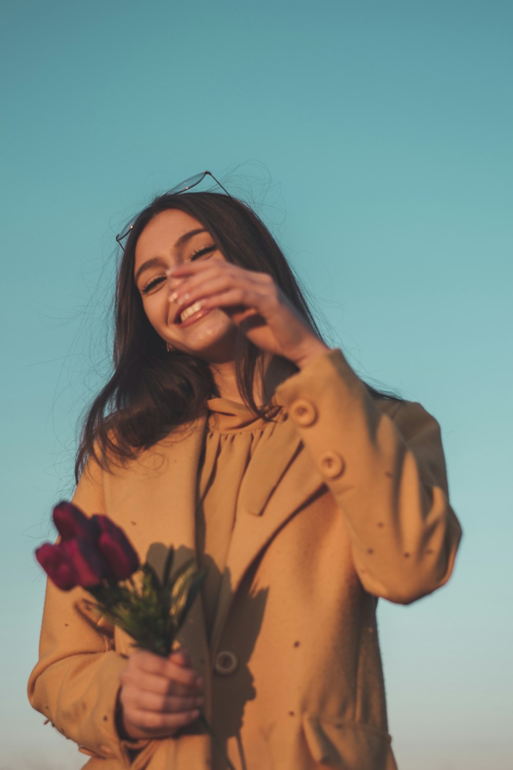 a woman holding a bouquet of flowers in her hands