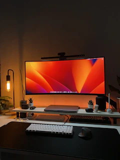a desk with a computer monitor and keyboard