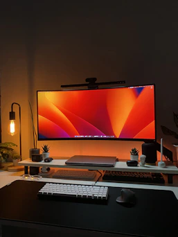 a desk with a computer monitor and keyboard