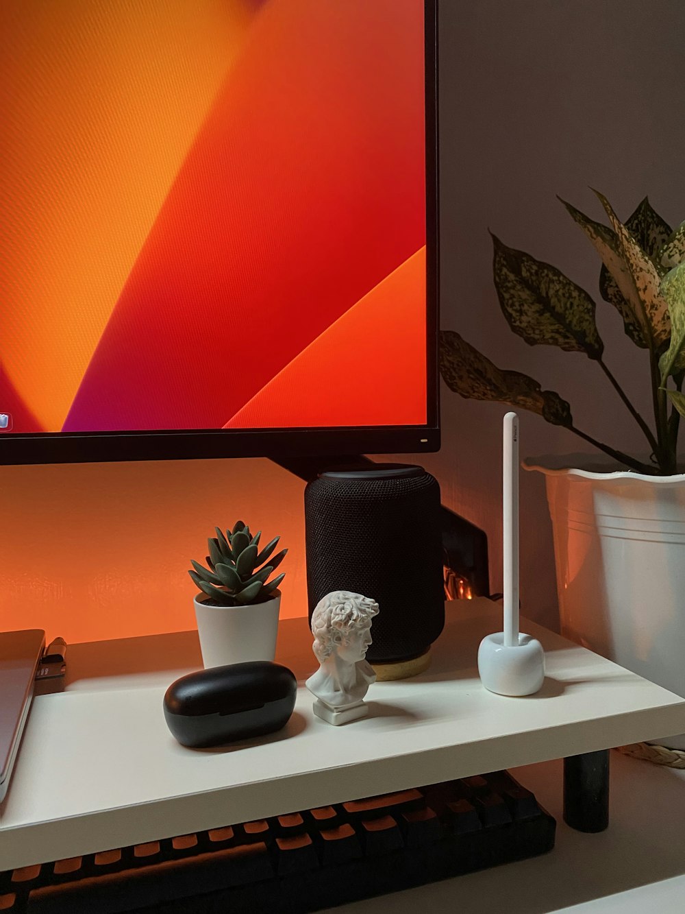 a flat screen tv sitting on top of a white table