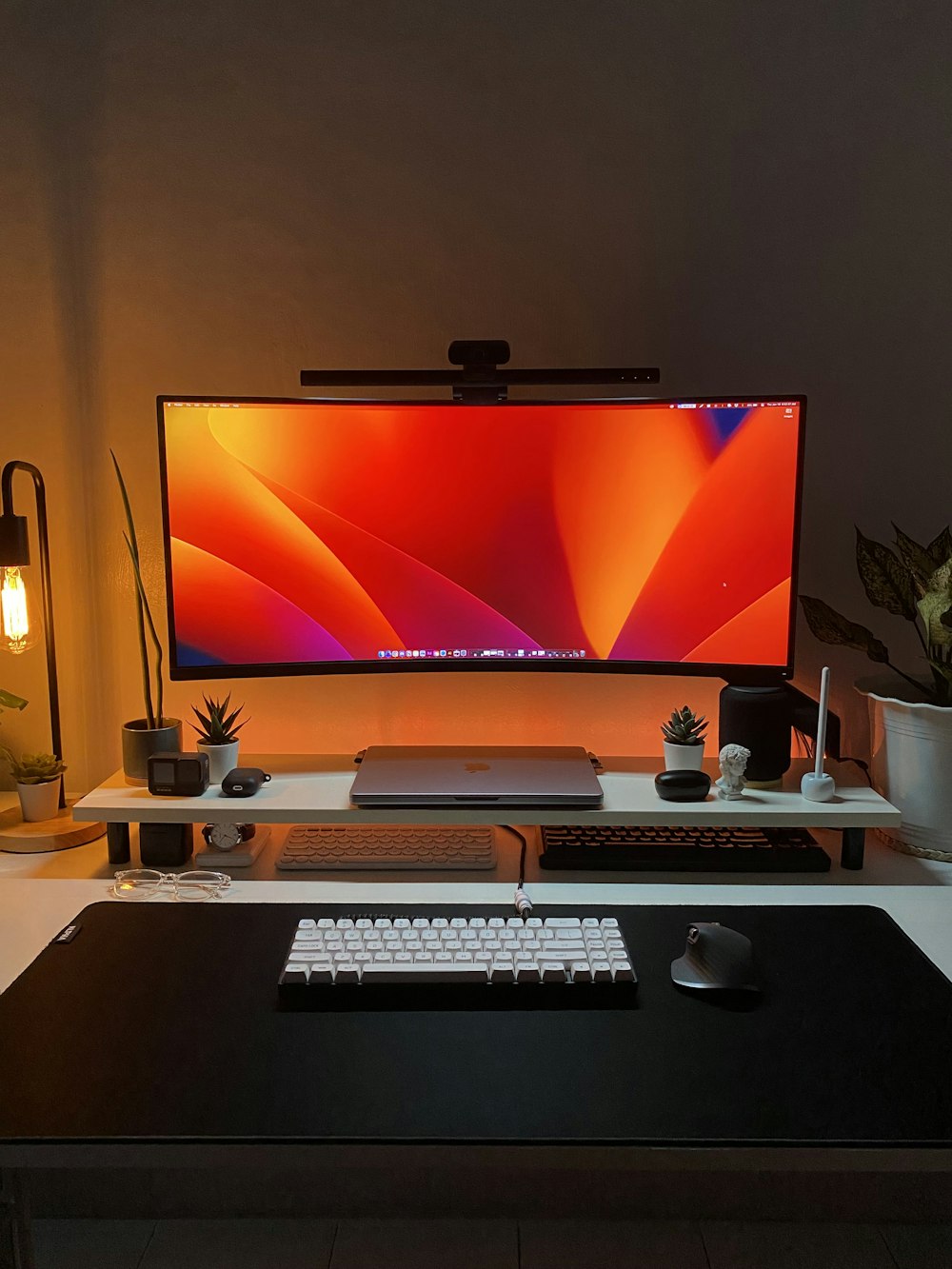 a desk with a monitor, keyboard and mouse