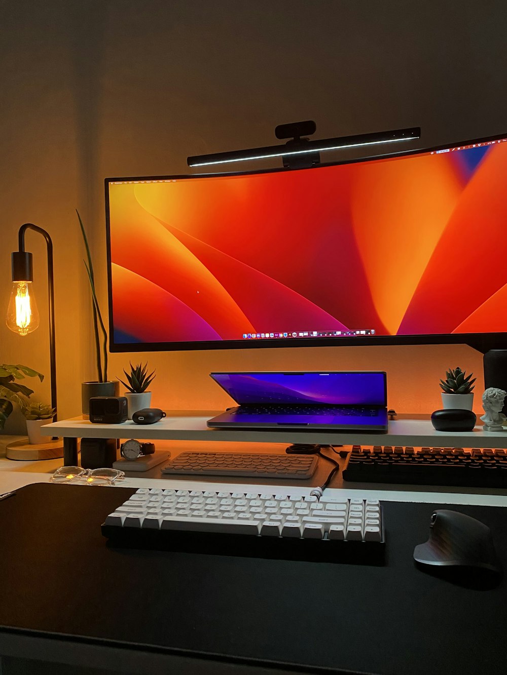 a desk with a monitor, keyboard and mouse