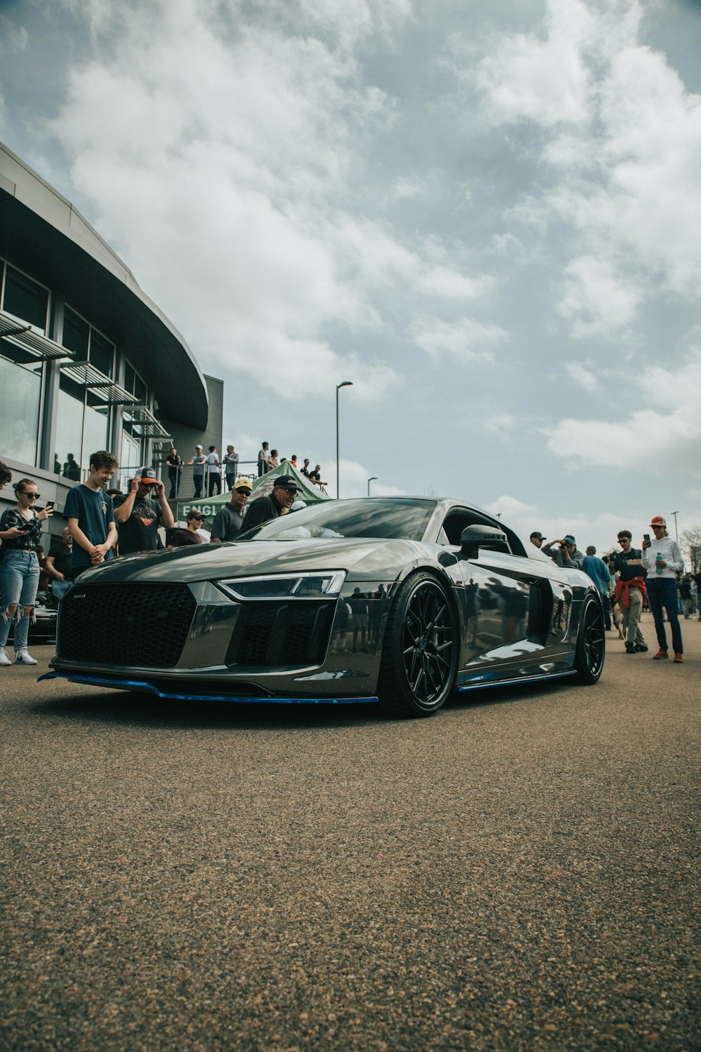 a car parked in front of a crowd of people