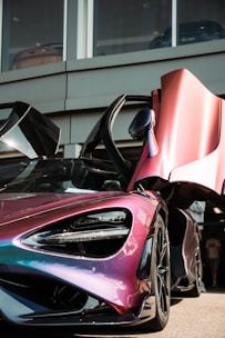 A sleek car mid-wrap with vibrant colors blending smoothly along its curves.
