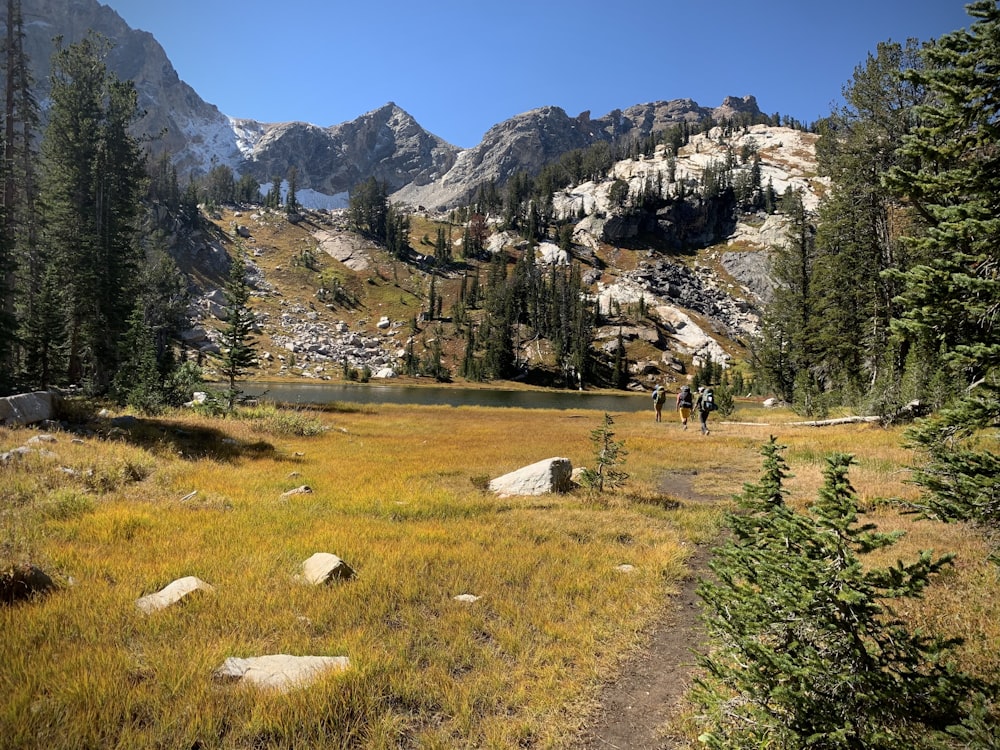 a man hiking up a trail in the mountains