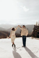 Snow-capped mountains framing a romantic couple’s walk in Himachal Pradesh.