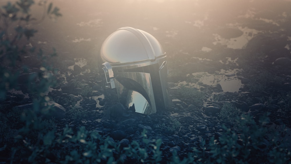 a helmet sitting in the middle of a field