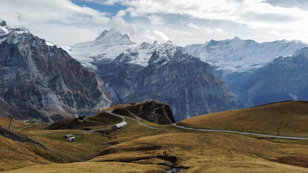 a mountain range with a winding road in the foreground,