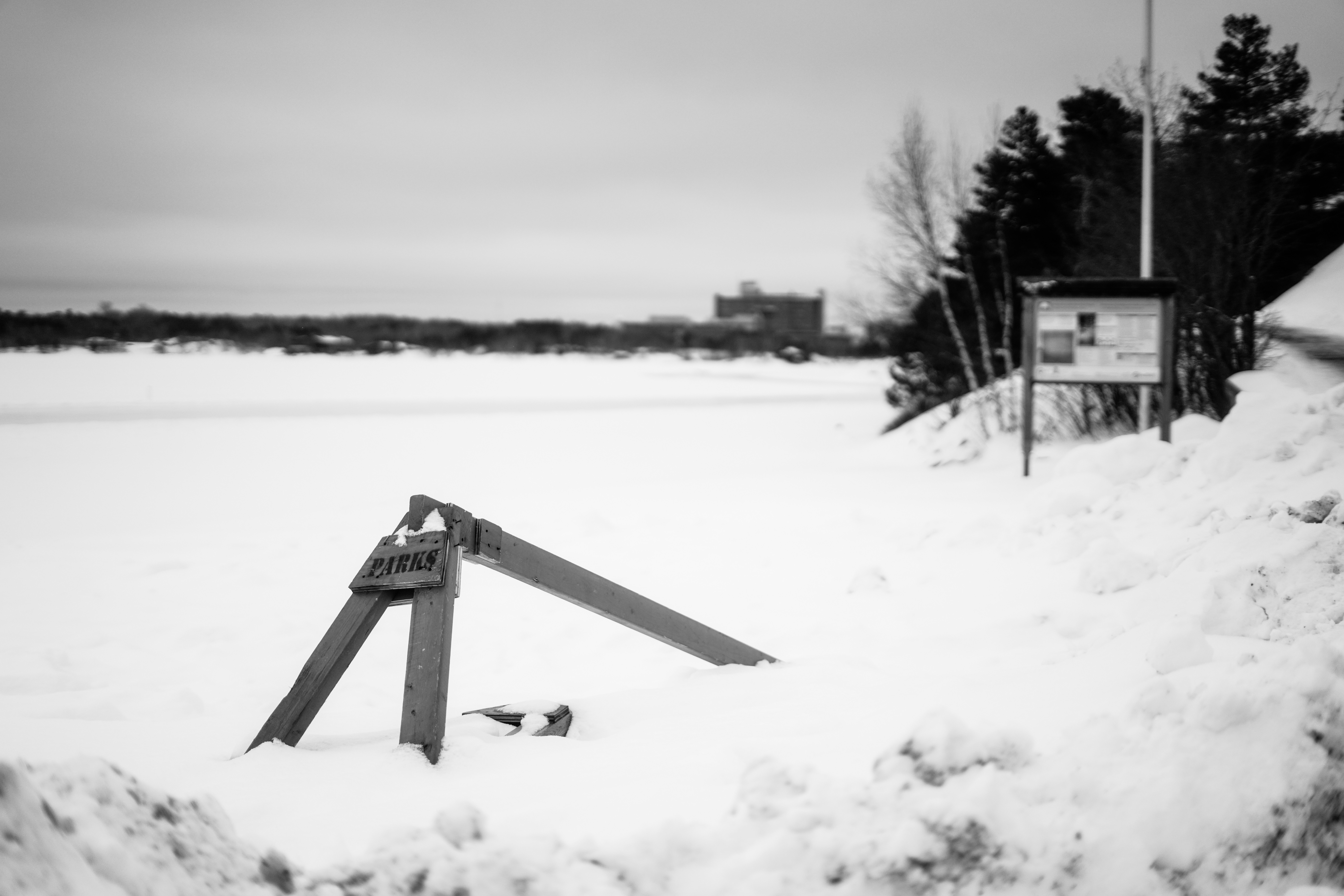 a black and white photo of a sign in the snow